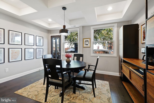 dining room with coffered ceiling and dark hardwood / wood-style floors