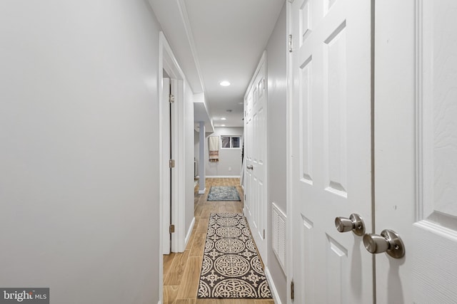 corridor with light hardwood / wood-style flooring