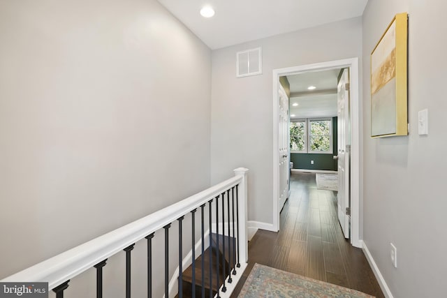 hallway with dark hardwood / wood-style floors