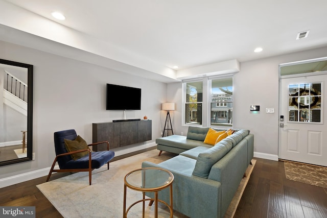 living room with a healthy amount of sunlight and dark wood-type flooring