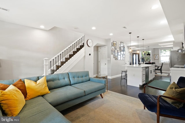 living room with sink and dark wood-type flooring