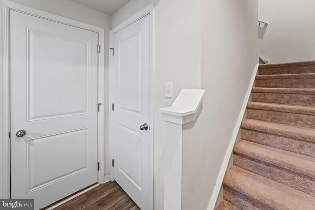 stairs featuring hardwood / wood-style floors