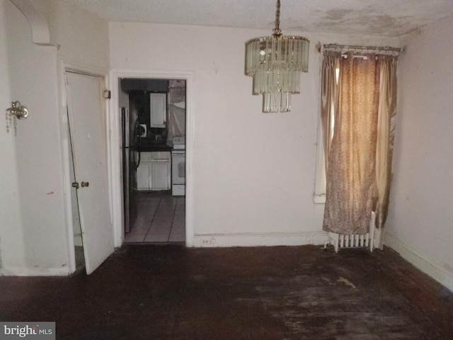 unfurnished dining area with a chandelier and tile patterned flooring