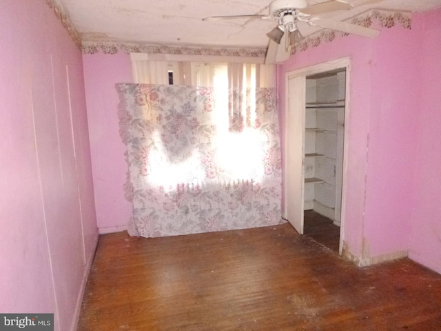 unfurnished bedroom with hardwood / wood-style flooring, ceiling fan, and a closet