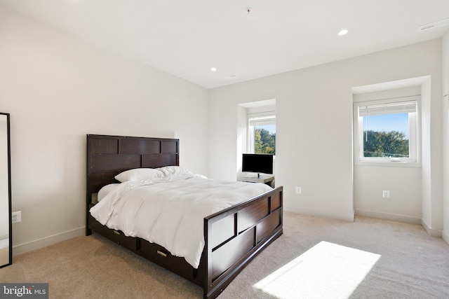 bedroom featuring light carpet, baseboards, and recessed lighting