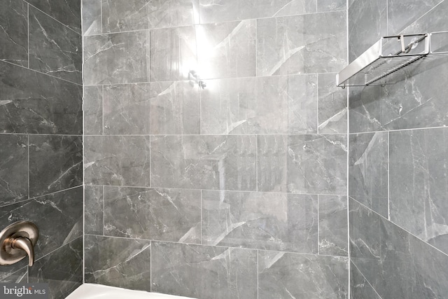 bathroom with tiled shower