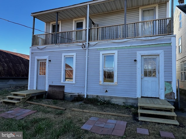 back of house with a balcony