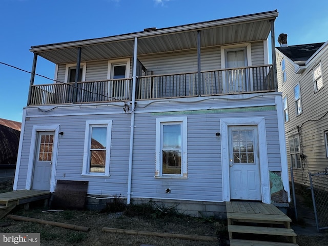 back of property with a balcony