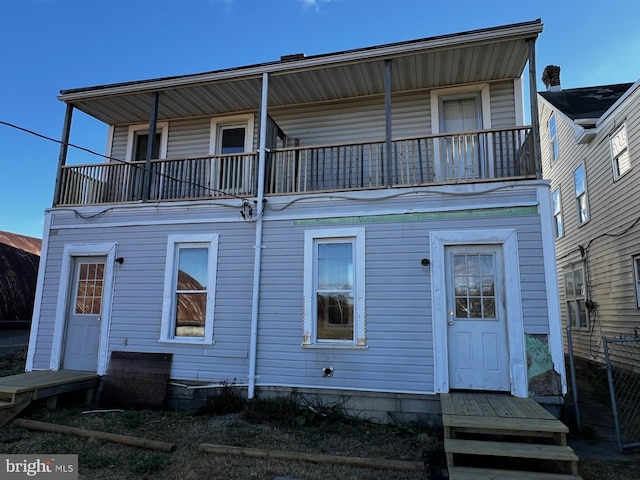 back of house featuring a balcony