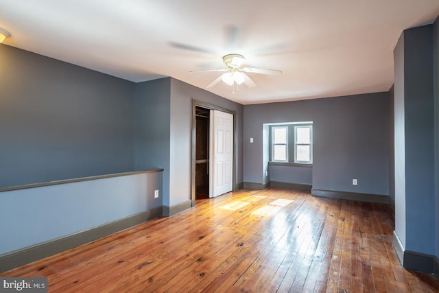 unfurnished room featuring ceiling fan and light hardwood / wood-style floors