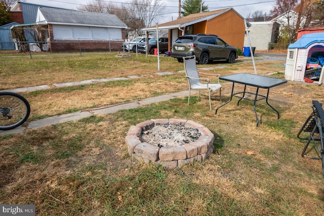 view of yard with an outdoor fire pit