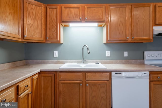 kitchen featuring range hood, sink, and white appliances