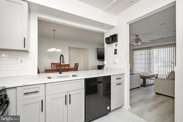 kitchen with light stone counters, ceiling fan, sink, black appliances, and white cabinets