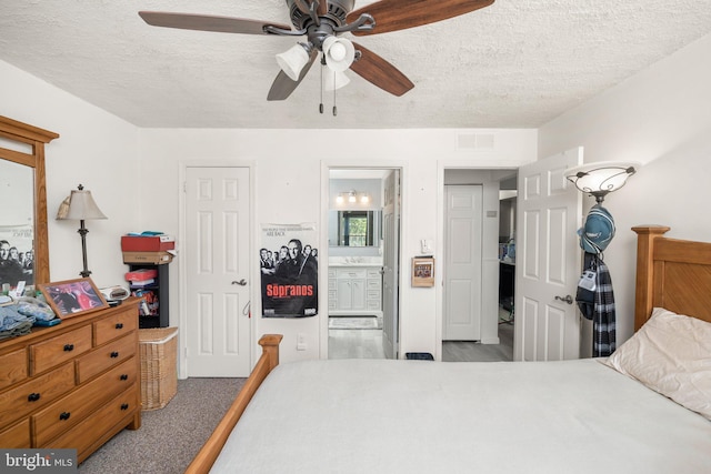 bedroom featuring connected bathroom, ceiling fan, carpet floors, and a textured ceiling