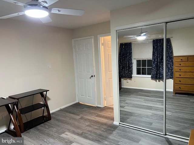 bedroom with ceiling fan, a closet, and hardwood / wood-style floors