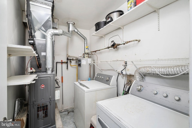 washroom featuring washing machine and dryer and water heater