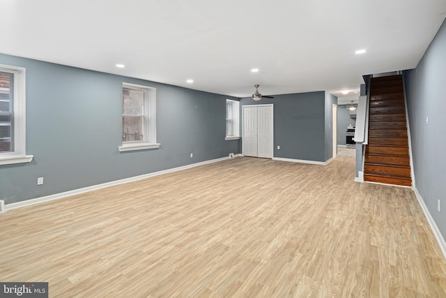 unfurnished living room with ceiling fan and light hardwood / wood-style flooring