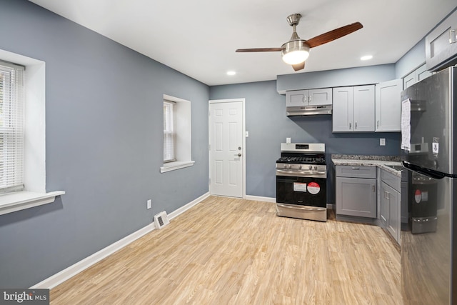 kitchen with gray cabinetry, ceiling fan, light hardwood / wood-style floors, and appliances with stainless steel finishes