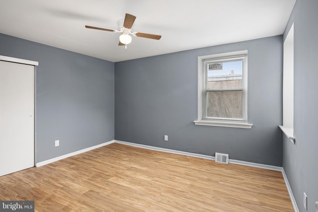 unfurnished room featuring ceiling fan and light wood-type flooring