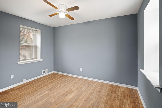 empty room featuring light hardwood / wood-style flooring and ceiling fan