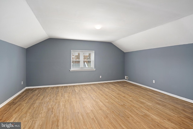 bonus room featuring light hardwood / wood-style flooring and lofted ceiling