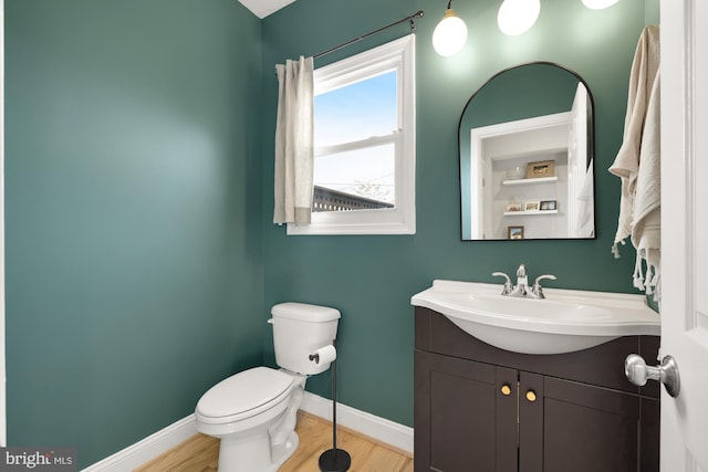 bathroom featuring vanity, hardwood / wood-style flooring, and toilet