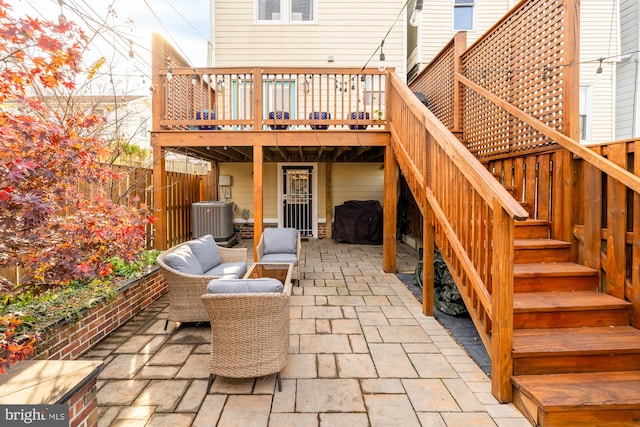 view of patio / terrace with outdoor lounge area, central AC unit, and a wooden deck