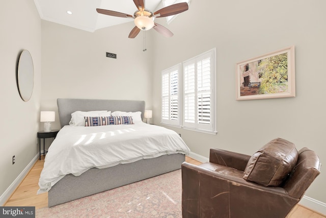 bedroom featuring ceiling fan, crown molding, wood-type flooring, and lofted ceiling