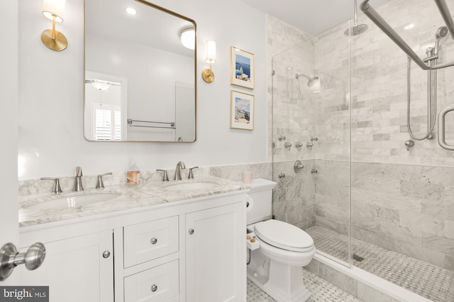 bathroom featuring vanity, tile patterned floors, toilet, walk in shower, and tile walls