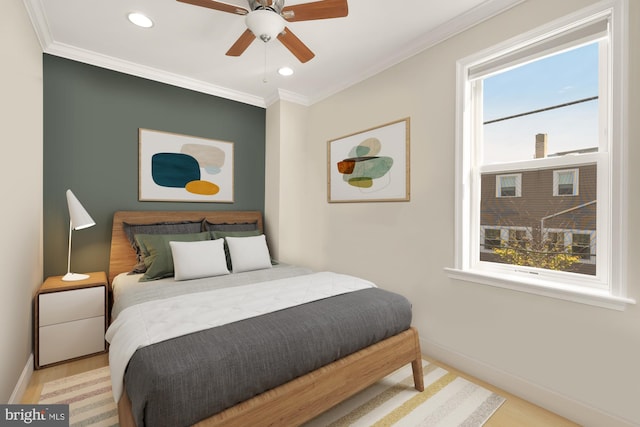 bedroom featuring multiple windows, light hardwood / wood-style floors, ceiling fan, and crown molding