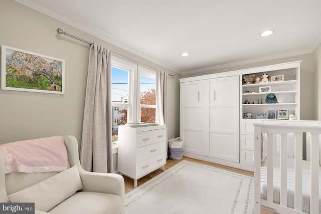 bedroom with light hardwood / wood-style flooring and crown molding