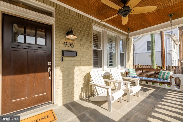 property entrance with covered porch and ceiling fan