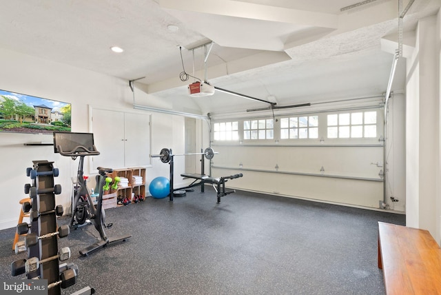 exercise area with a garage, a textured ceiling, and recessed lighting