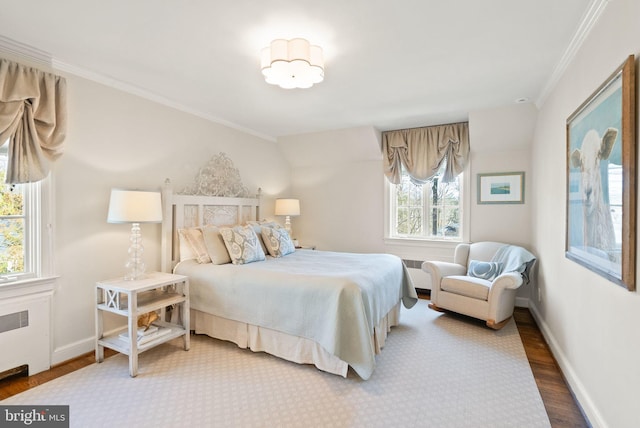 bedroom with ornamental molding, baseboards, radiator heating unit, and wood finished floors