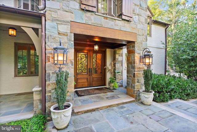 entrance to property with stone siding