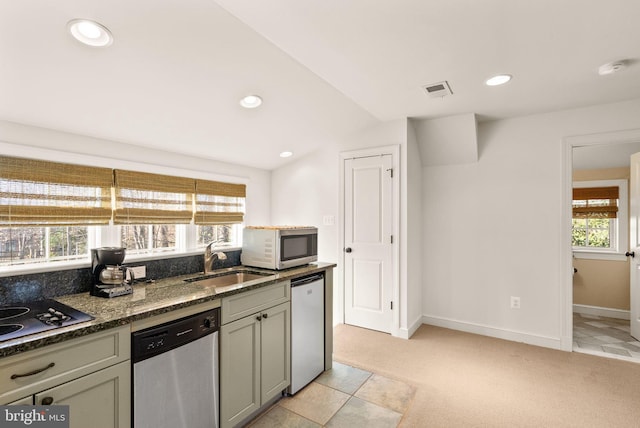 kitchen with dishwasher, white microwave, a sink, and electric stovetop