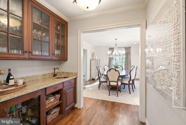 interior space featuring a notable chandelier, crown molding, and dark wood-style flooring