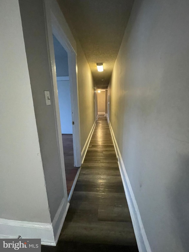 corridor with dark hardwood / wood-style floors