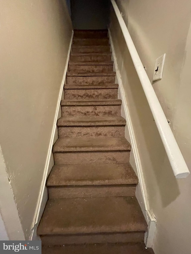 stairs with hardwood / wood-style flooring