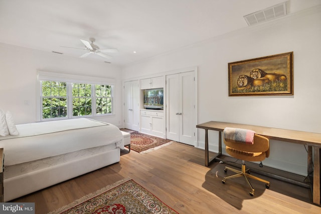 bedroom with ceiling fan and wood-type flooring