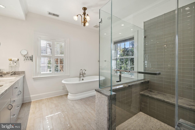 bathroom with independent shower and bath, ornamental molding, a chandelier, and vanity