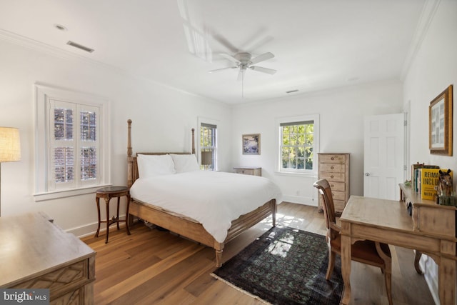 bedroom with ceiling fan, hardwood / wood-style flooring, and crown molding