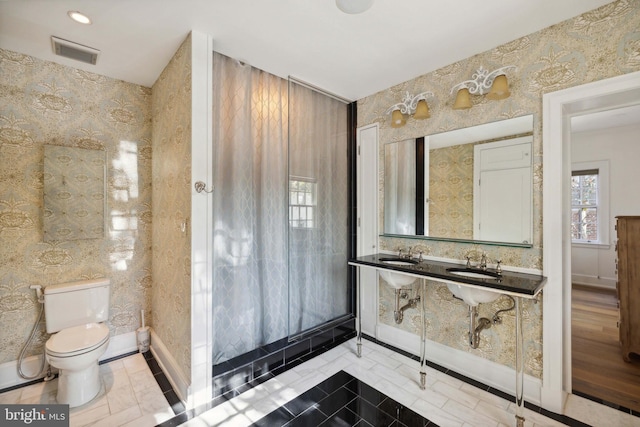 bathroom featuring sink, toilet, and tile patterned flooring