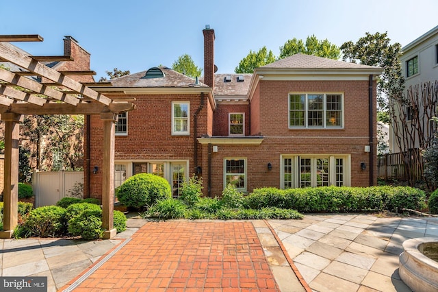 back of property featuring a pergola and a patio area