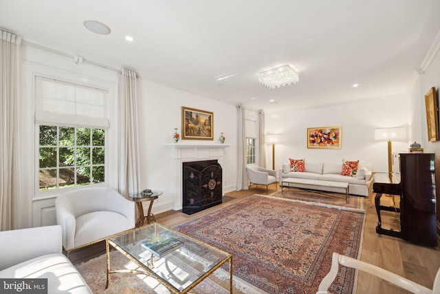 living room with light hardwood / wood-style flooring and ornamental molding