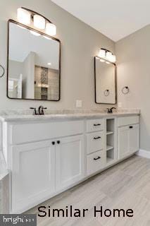 bathroom with hardwood / wood-style floors and vanity