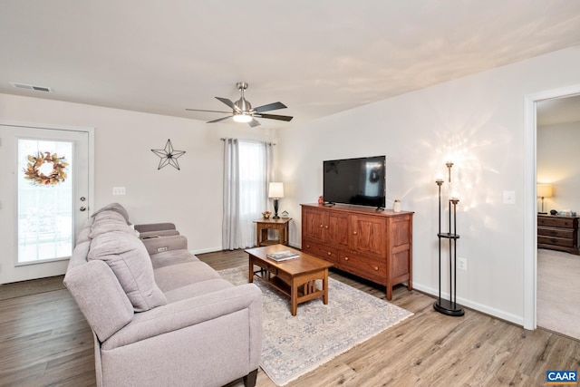 living room featuring hardwood / wood-style floors, ceiling fan, and a healthy amount of sunlight