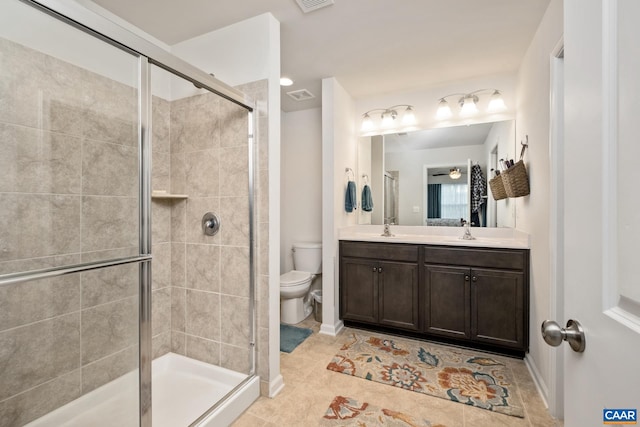 bathroom featuring ceiling fan, tile patterned flooring, an enclosed shower, toilet, and vanity