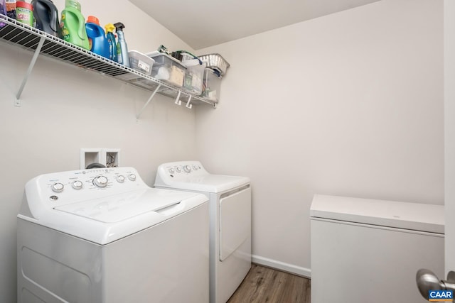 laundry room with hardwood / wood-style flooring and washer and dryer