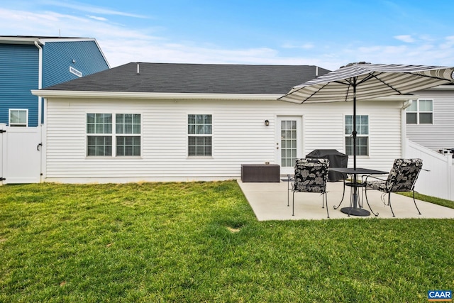 rear view of house with a yard and a patio area